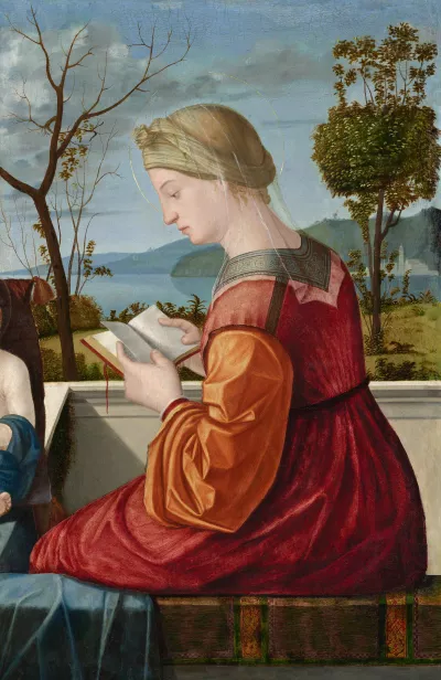 Mary is shown from behind, sitting on a balcony balustrade in front of a landscape with water. She is looking at an open book.